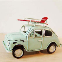 Sky blue miniature car with red surfboard