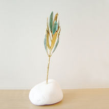 Real olive branch eco sculpture on white stone