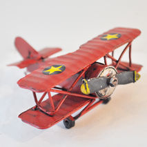 Miniature, retro metal red aeroplane