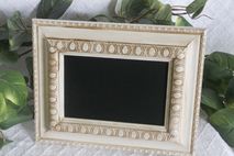 Small ornate white framed chalkboard