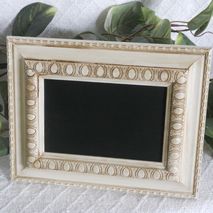 Small ornate white framed chalkboard